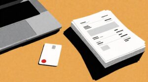 Business bank account card on a desk with laptop and invoices for freelancer setup guide